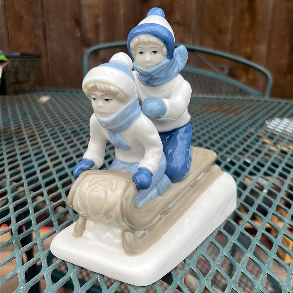 Paul Sebastian Porcelain Sledding Figurine in Blue and White 1992 Christmas Snow
